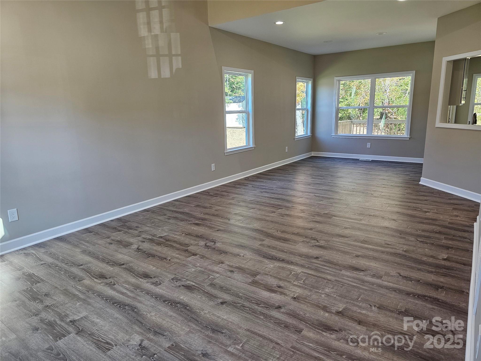 3679 Travertine Drive Lancaster, SC 29720 - Photo 3 of 26 an empty room with wooden floor and windows