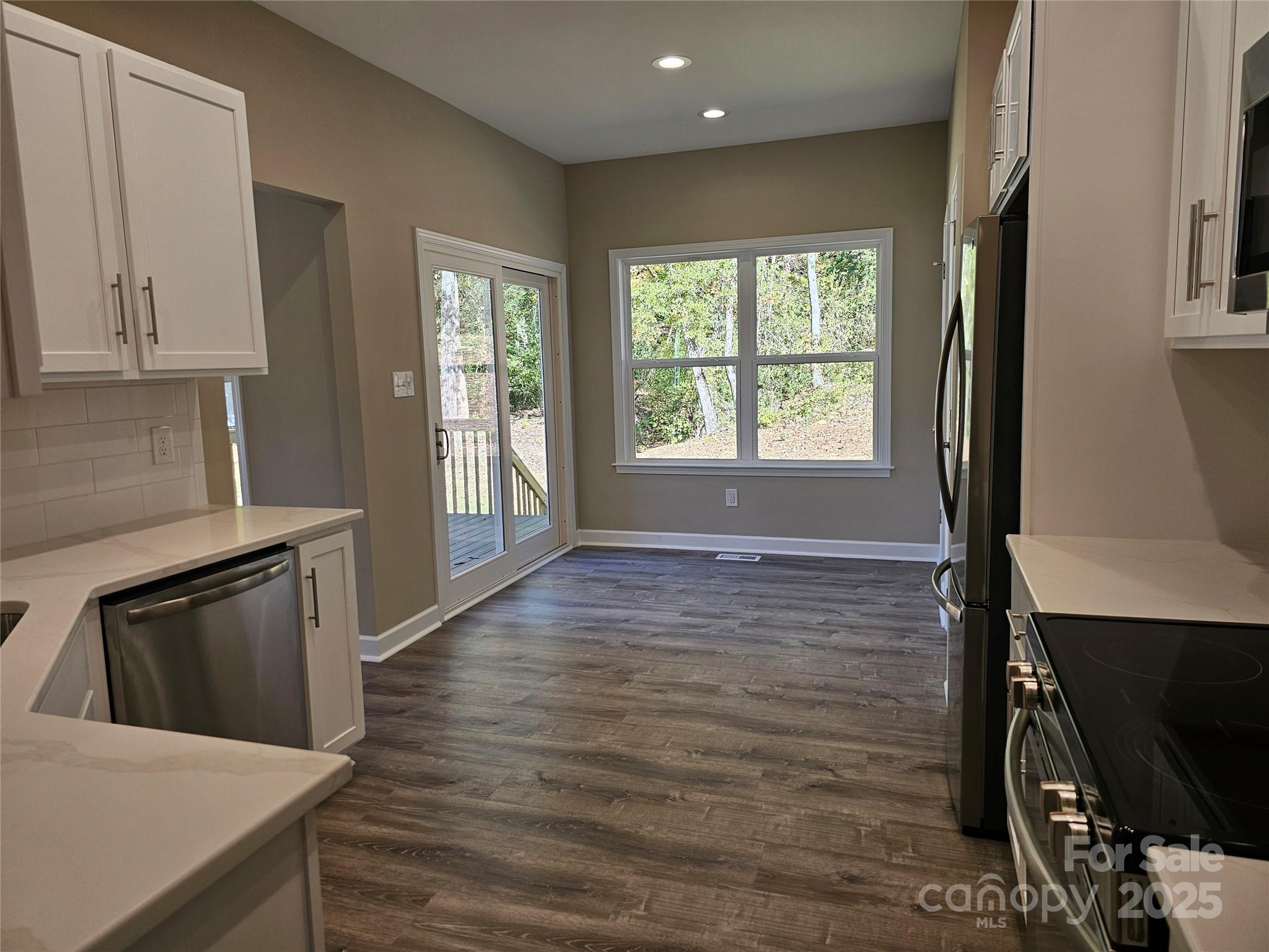 3679 Travertine Drive Lancaster, SC 29720 - Photo 7 of 26 a view of a kitchen cabinets a stove and wooden floor