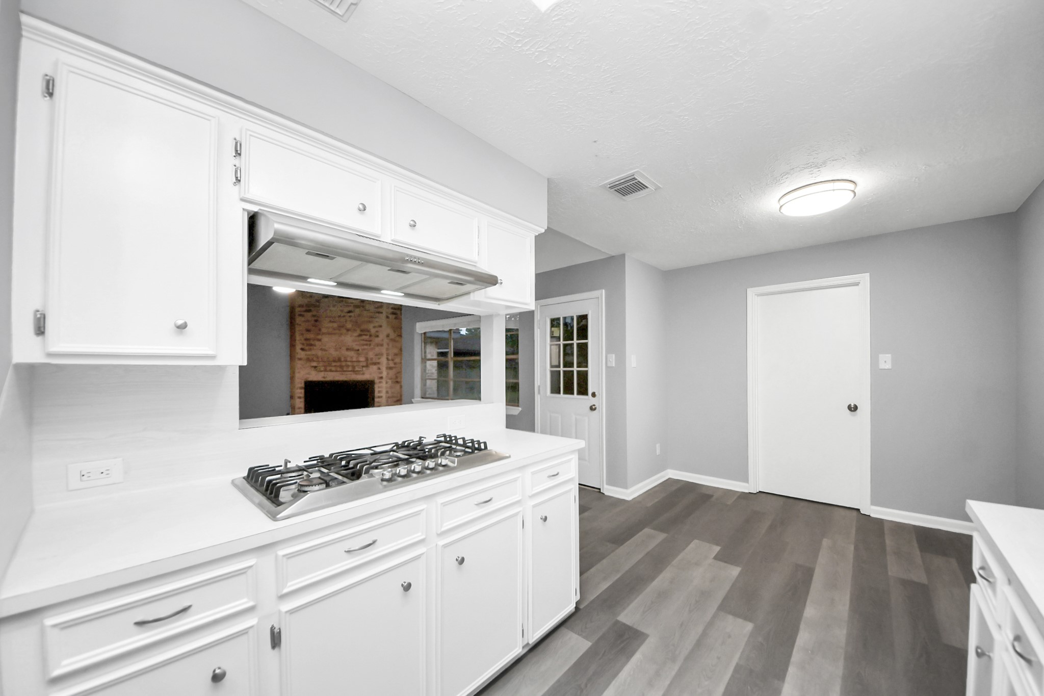 2522 Nightowl Trail Spring, TX 77373 - Photo 17 of 40 a kitchen with a stove and white cabinets