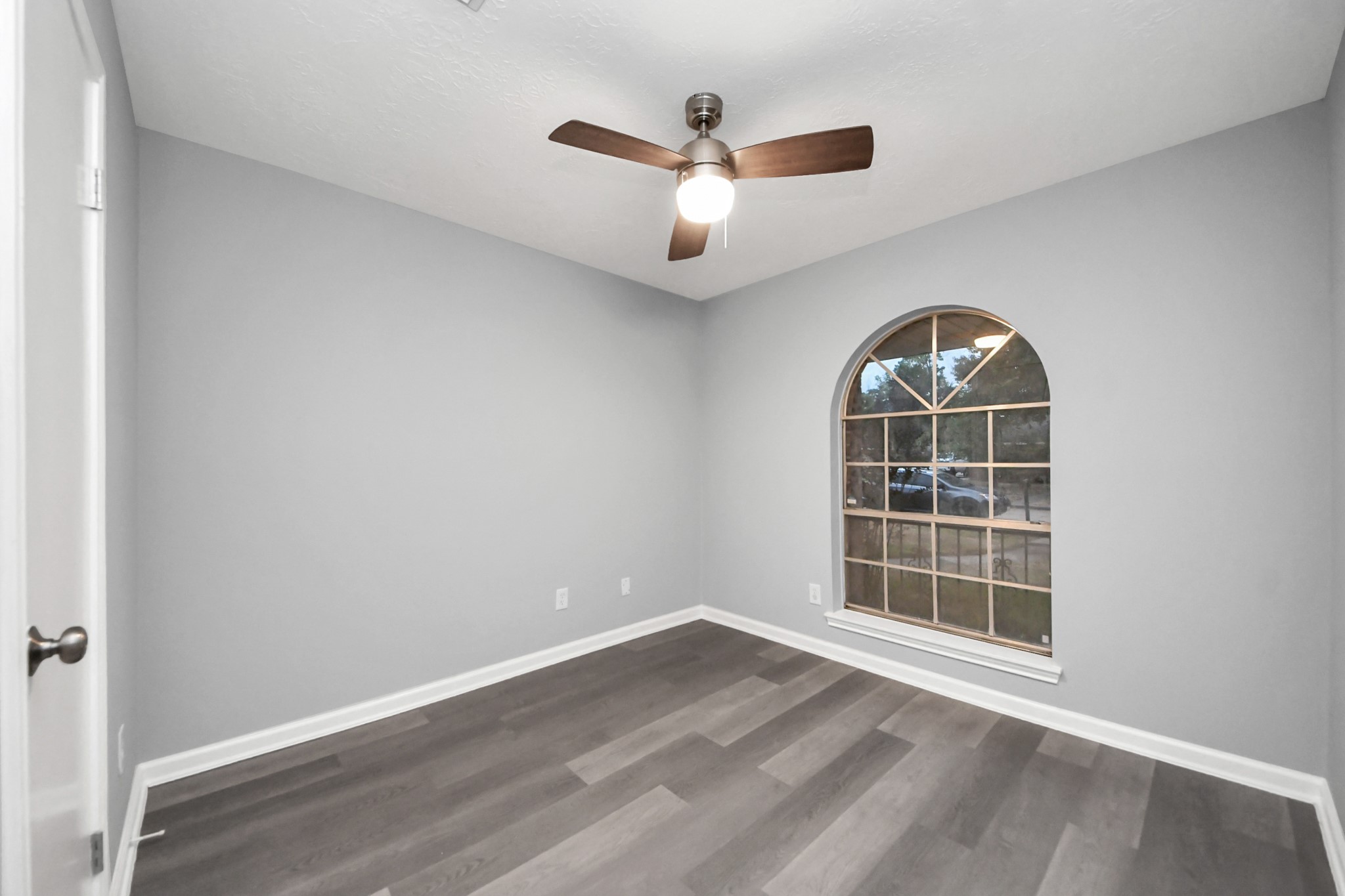 2522 Nightowl Trail Spring, TX 77373 - Photo 27 of 40 an empty room with wooden floor ceiling fan and windows