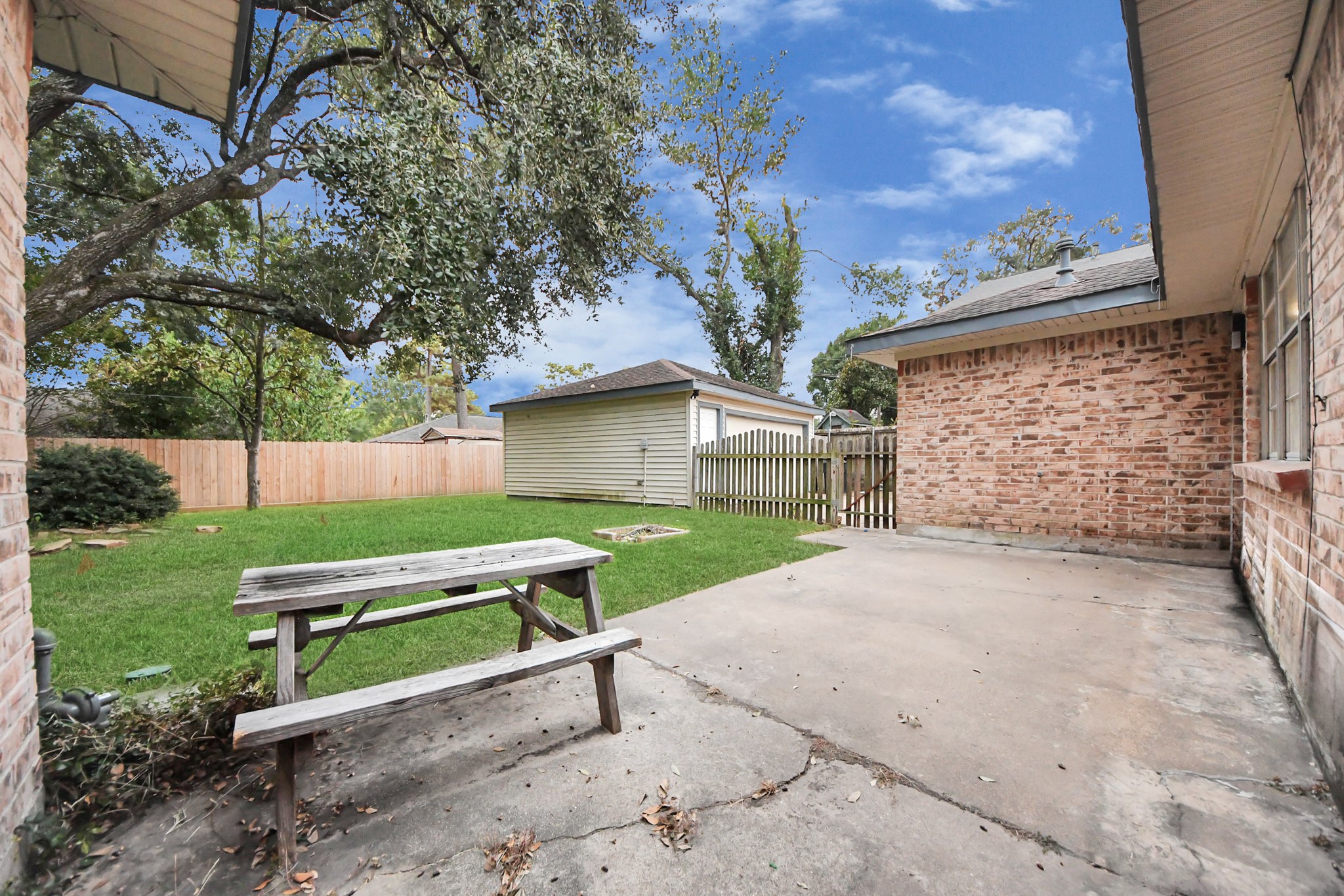 2522 Nightowl Trail Spring, TX 77373 - Photo 33 of 40 a wooden bench sitting in backyard of house