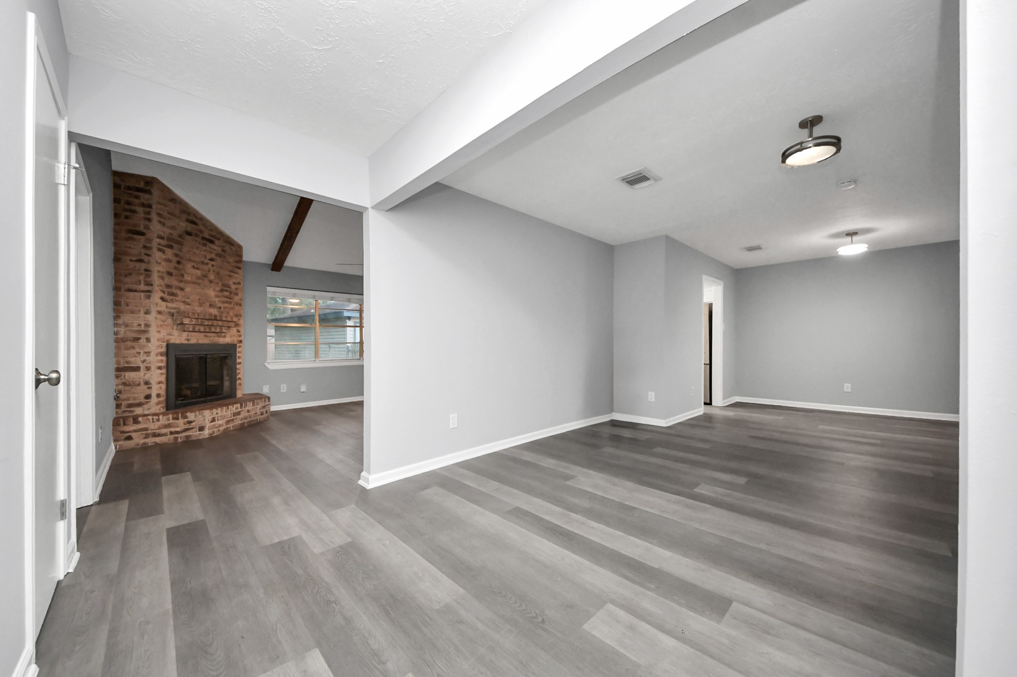 2522 Nightowl Trail Spring, TX 77373 - Photo 5 of 40 a view of an empty room with wooden floor fireplace and a window