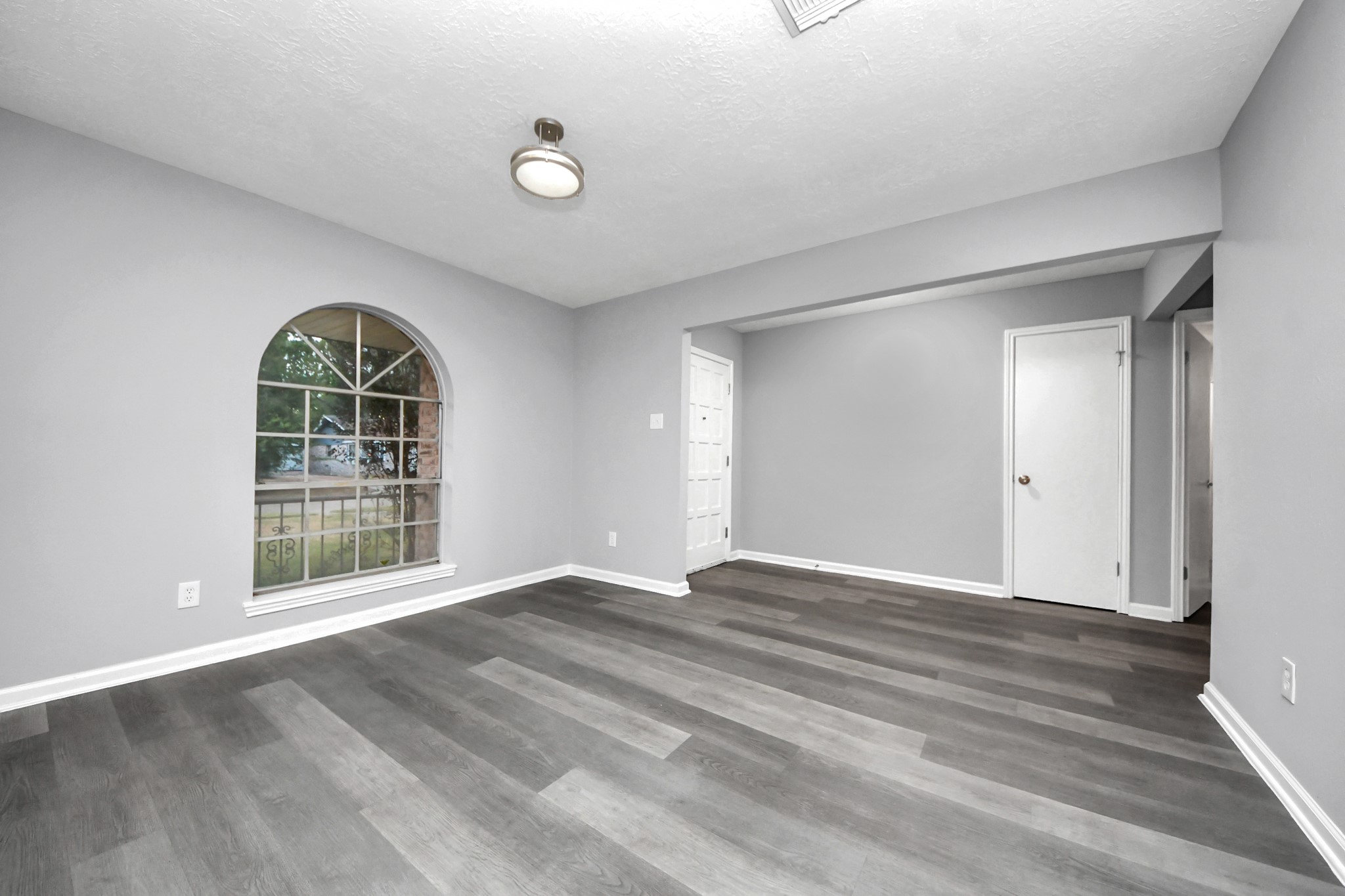 2522 Nightowl Trail Spring, TX 77373 - Photo 7 of 40 a view of an empty room with wooden floor and a window