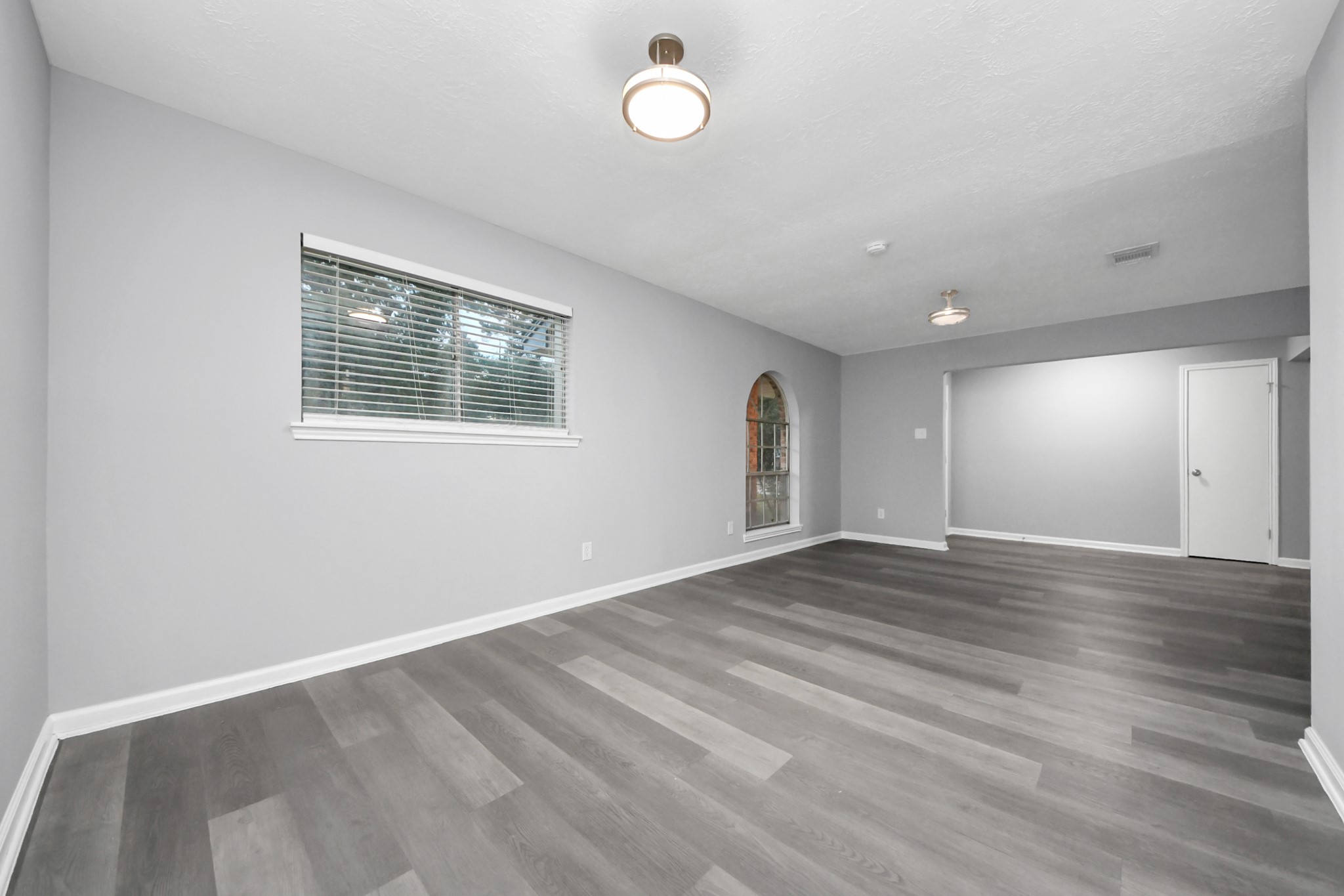 2522 Nightowl Trail Spring, TX 77373 - Photo 8 of 40 an empty room with wooden floor and windows