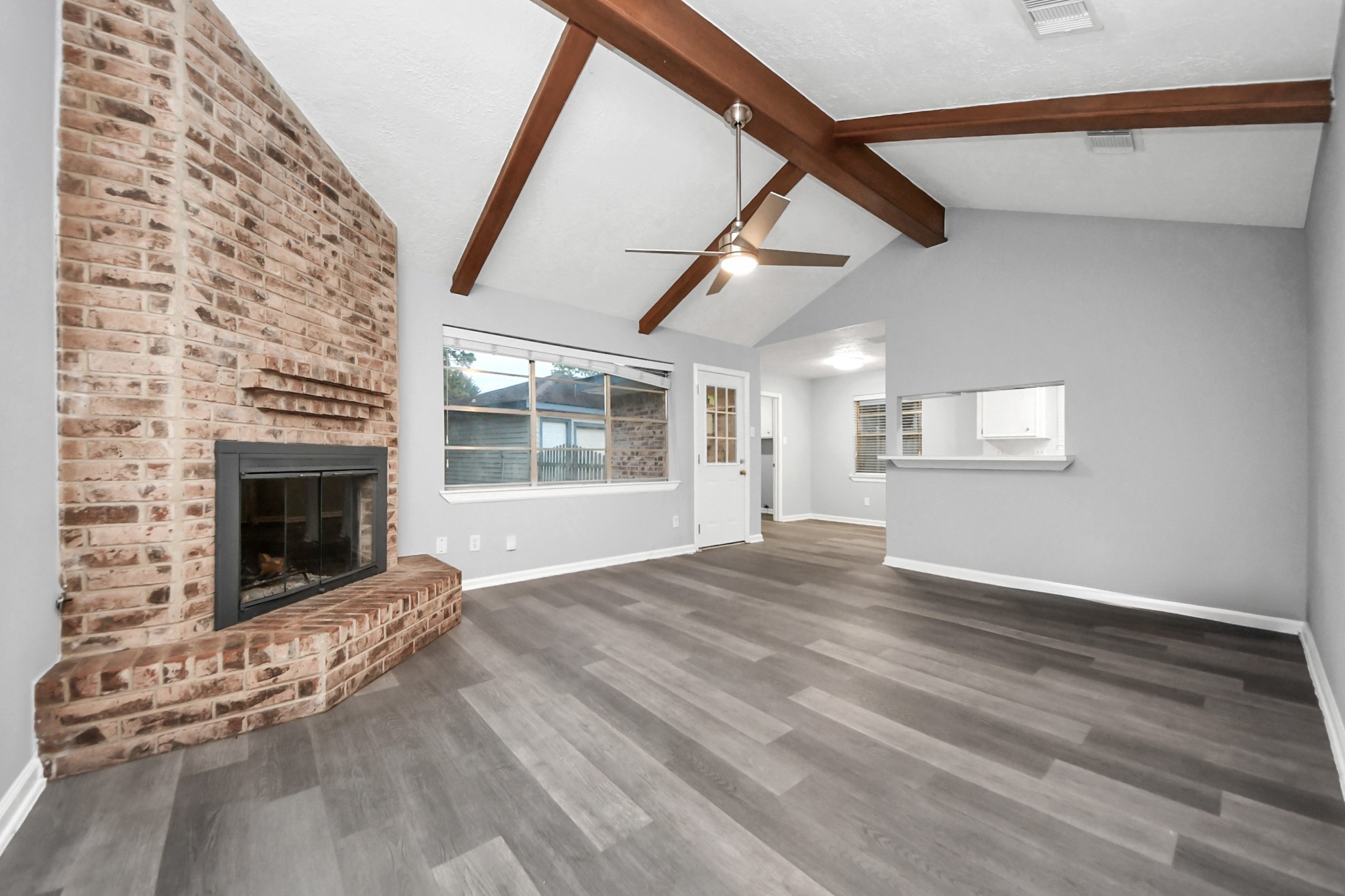 2522 Nightowl Trail Spring, TX 77373 - Photo 9 of 40 a view of an empty room with wooden floor fireplace and a window