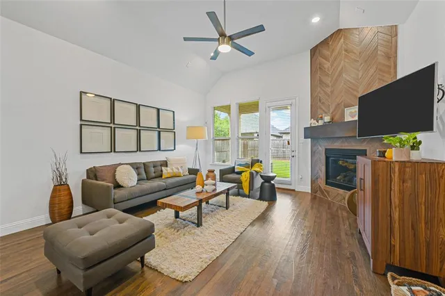 a living room with furniture a fireplace and a flat screen tv