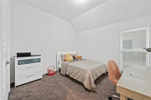 a bedroom with a bed and a cabinet