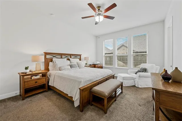 a spacious bedroom with a bed and a large window