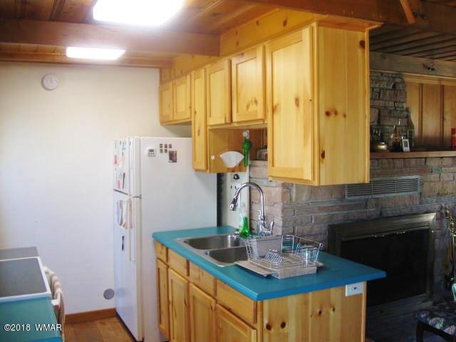 4 County Road Greer, AZ 85927 - Photo 11 of 24 a kitchen with a sink and a refrigerator