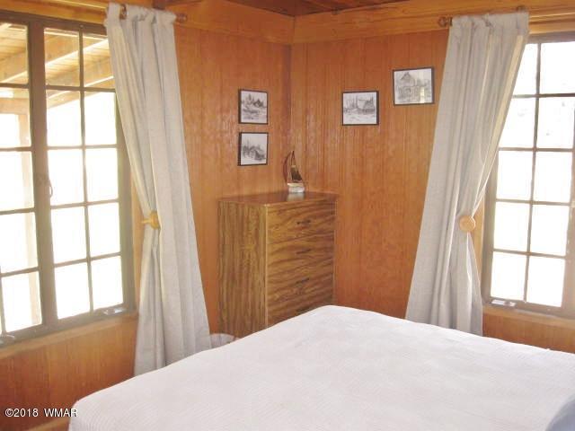 4 County Road Greer, AZ 85927 - Photo 13 of 24 a bedroom with a bed and a window