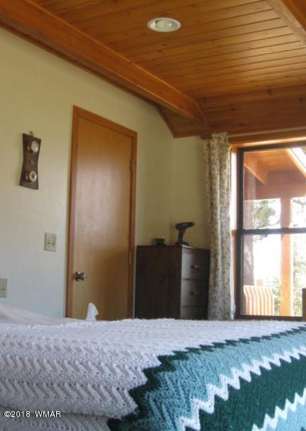 4 County Road Greer, AZ 85927 - Photo 22 of 24 a bedroom with a bed and a window