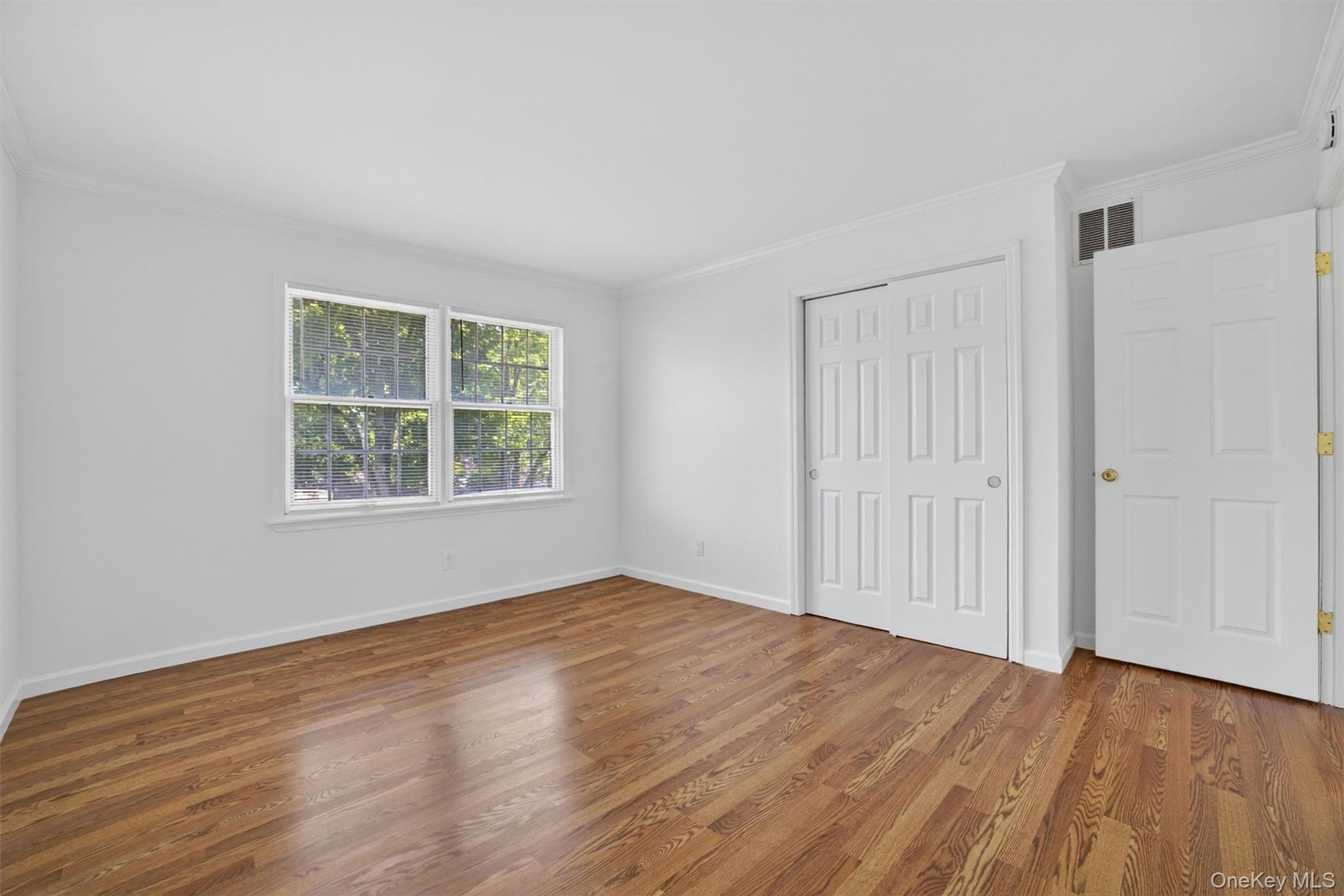 263 Croydon Road Yonkers, NY 10710 - Photo 24 of 43 a view of an empty room with wooden floor and a window