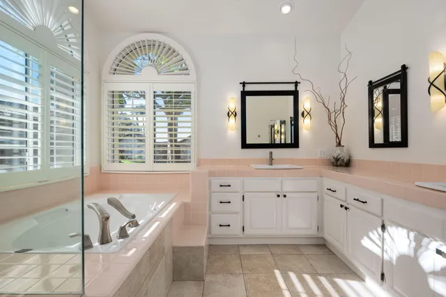 a bathroom with a tub shower and a sink