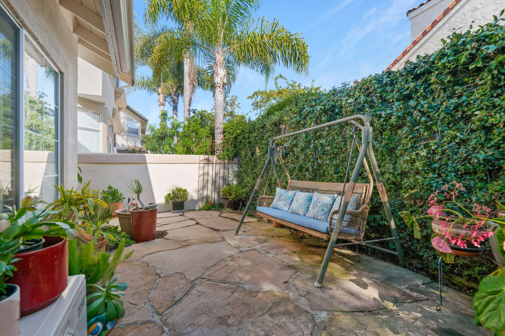 1260 Cravens Lane, Unit 2 Carpinteria, CA 93013 - Photo 18 of 23 a view of a chair and table in the garden