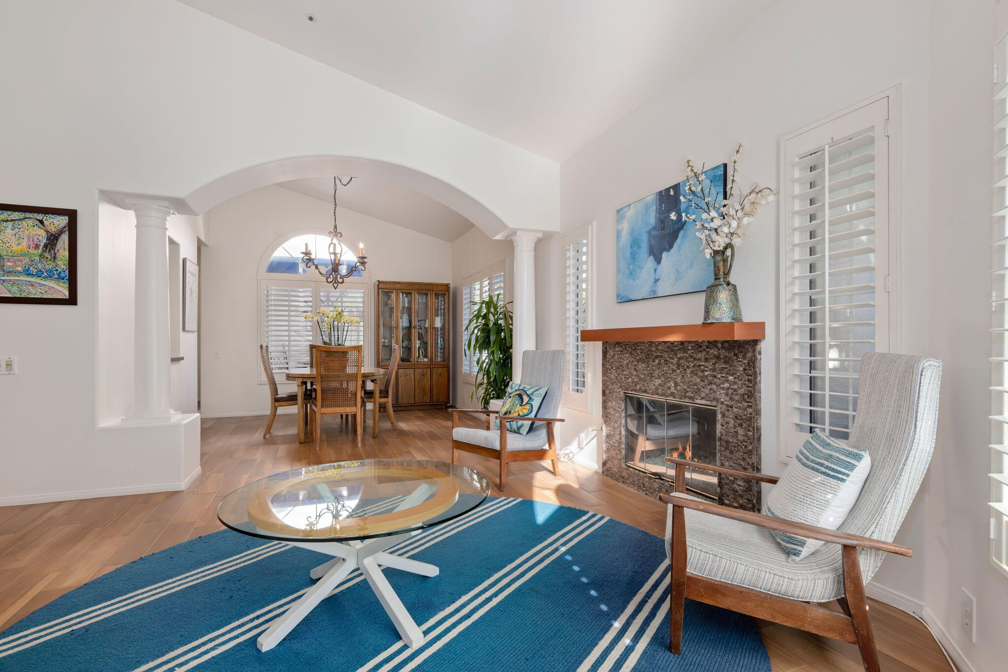 1260 Cravens Lane, Unit 2 Carpinteria, CA 93013 - Photo 4 of 23 a living room with furniture a fireplace and wooden floor
