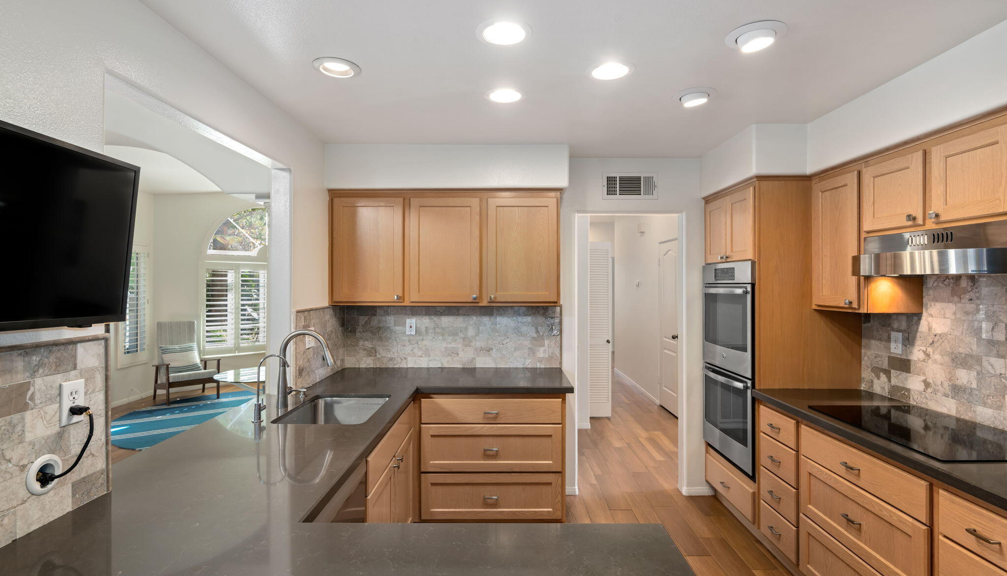 1260 Cravens Lane, Unit 2 Carpinteria, CA 93013 - Photo 7 of 23 a kitchen with stainless steel appliances granite countertop a stove a sink and a refrigerator