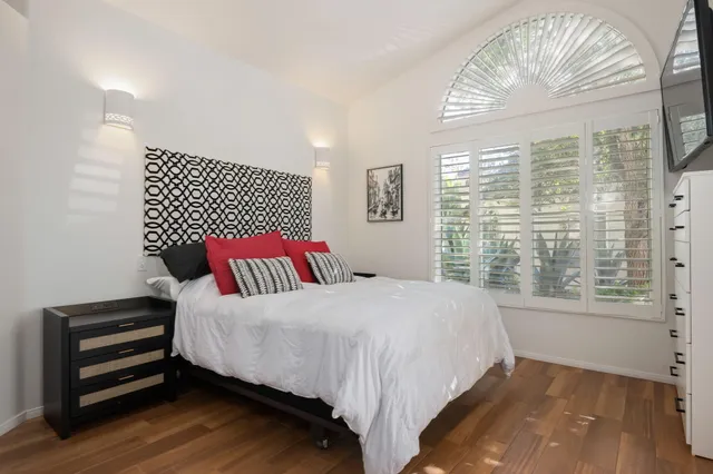 a bedroom with a bed and a flat screen tv