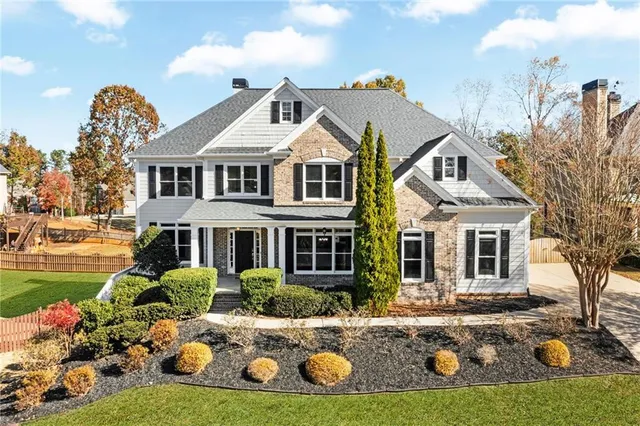 a front view of a house with garden