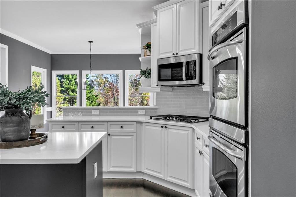 271 Ivy Hall Lane Dallas, GA 30132 - Photo 24 of 120 a kitchen with stainless steel appliances white cabinets and a stove top oven