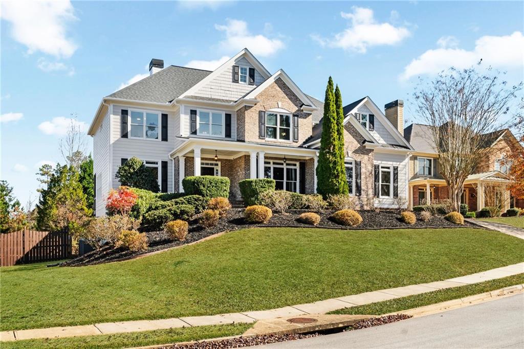 271 Ivy Hall Lane Dallas, GA 30132 - Photo 6 of 120 a front view of a house with a garden and trees