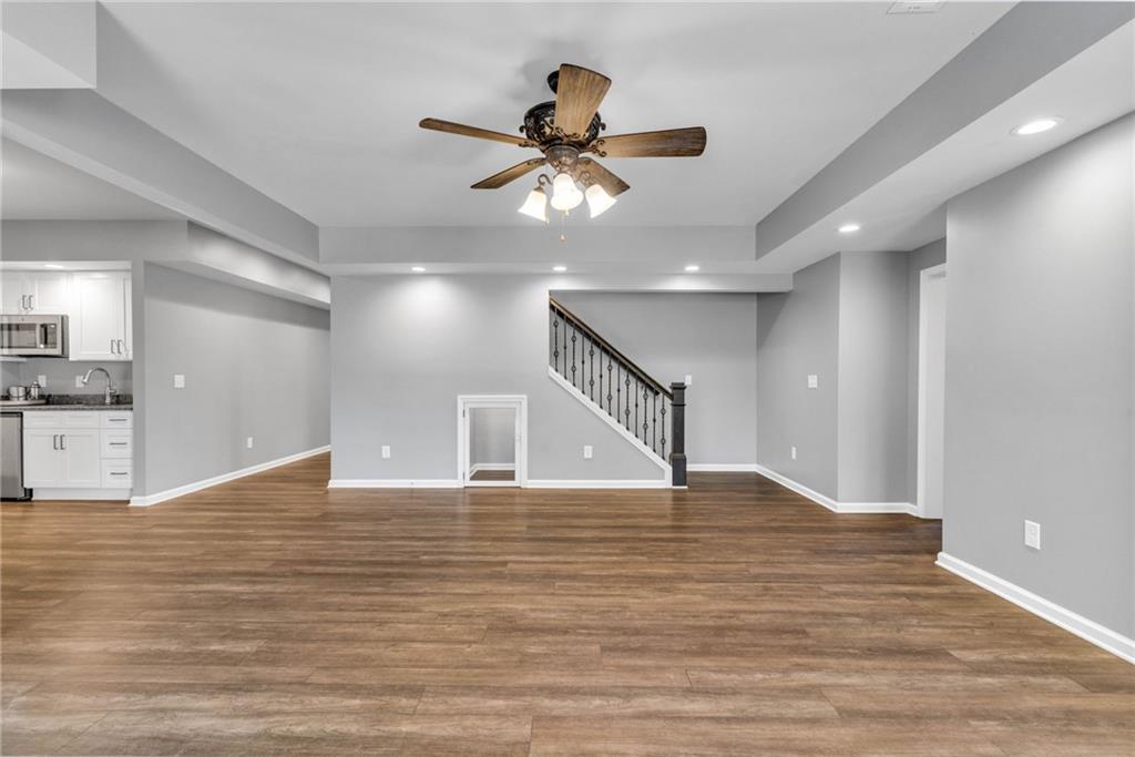 271 Ivy Hall Lane Dallas, GA 30132 - Photo 72 of 120 a view of an empty room with wooden floor and a ceiling fan