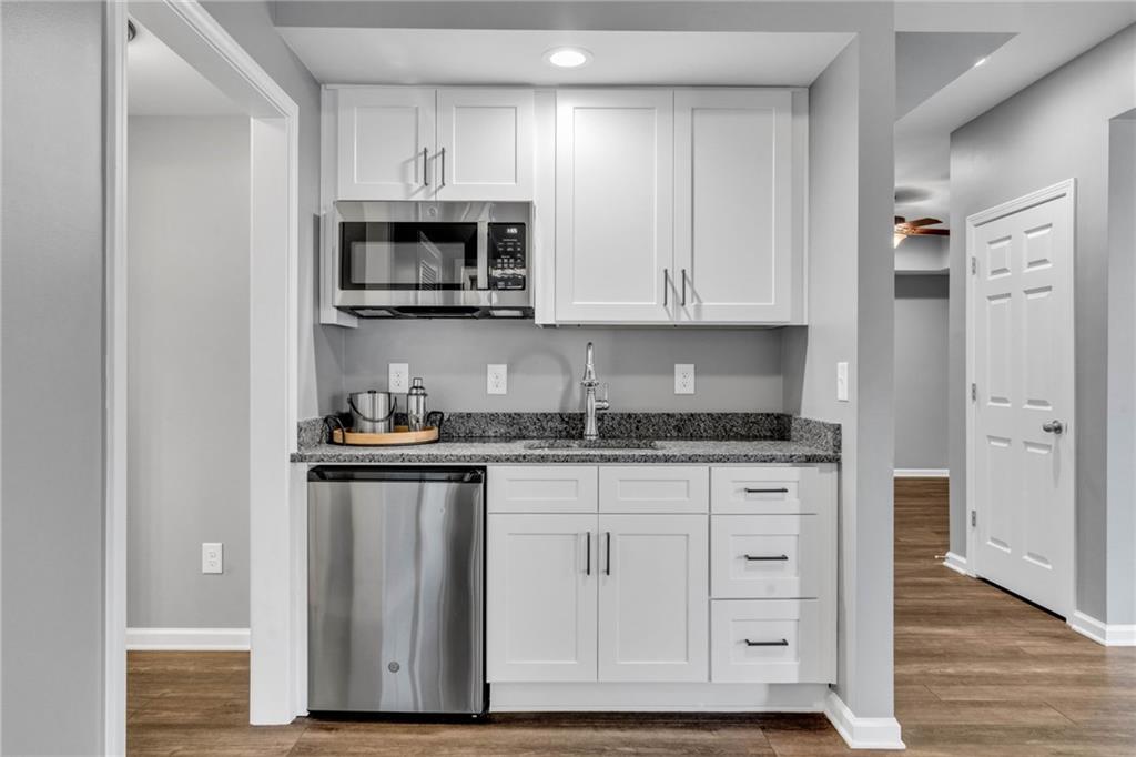 271 Ivy Hall Lane Dallas, GA 30132 - Photo 77 of 120 a kitchen with stainless steel appliances granite countertop a stove and a microwave
