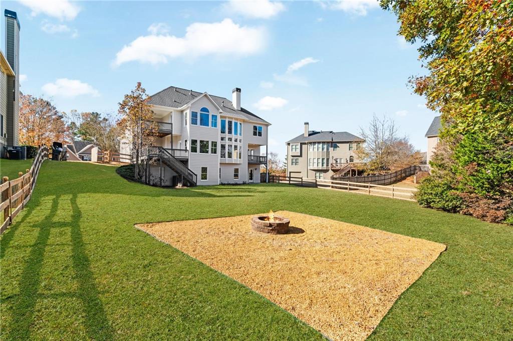 271 Ivy Hall Lane Dallas, GA 30132 - Photo 95 of 120 a view of a white house in front of a big yard with plants and large trees