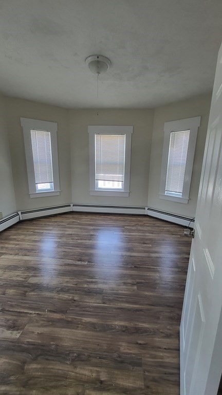 19 Delmont Avenue, Unit 19 Lowell, MA 01852 - Photo 12 of 14 a view of room with window and wooden floor