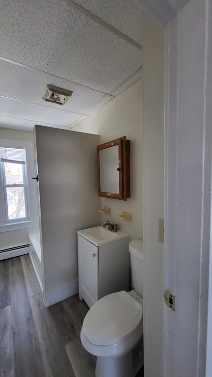 19 Delmont Avenue, Unit 19 Lowell, MA 01852 - Photo 9 of 14 a bathroom with a toilet a sink and mirror