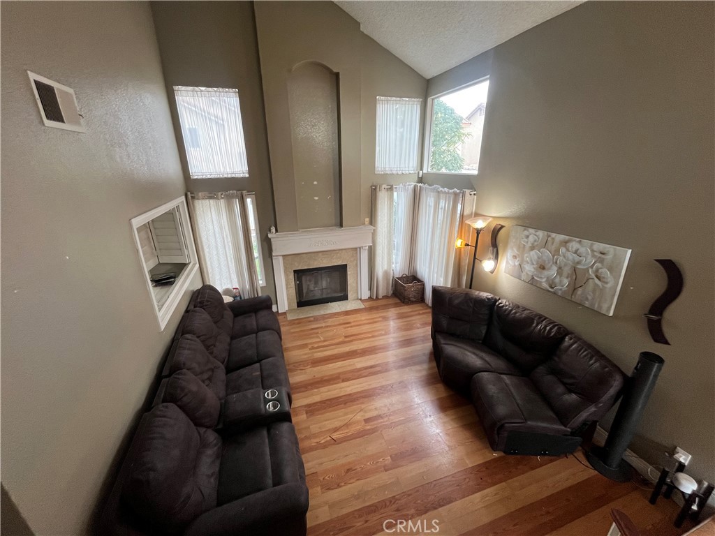 1491 Portrait Street Perris, CA 92571 - Photo 3 of 10 a living room with furniture and a fireplace
