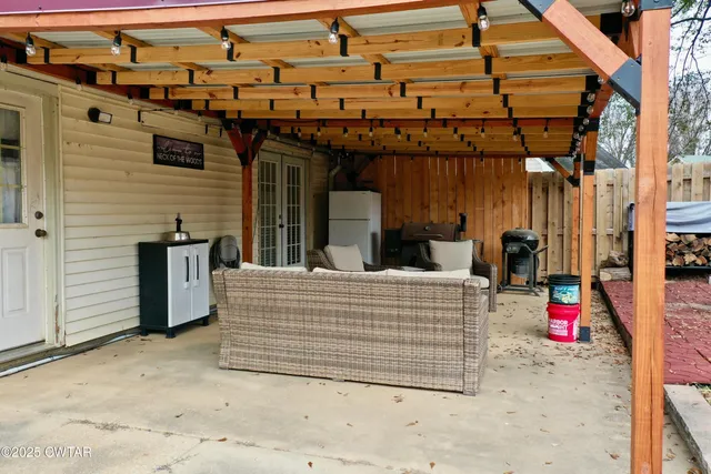a view of a patio with a table and chairs