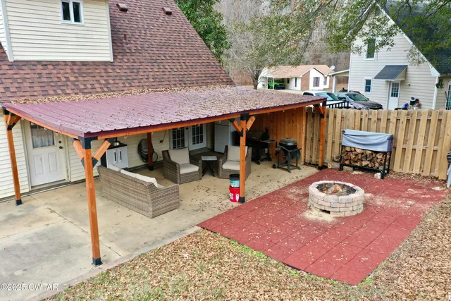 a front view of a house with a yard and furniture