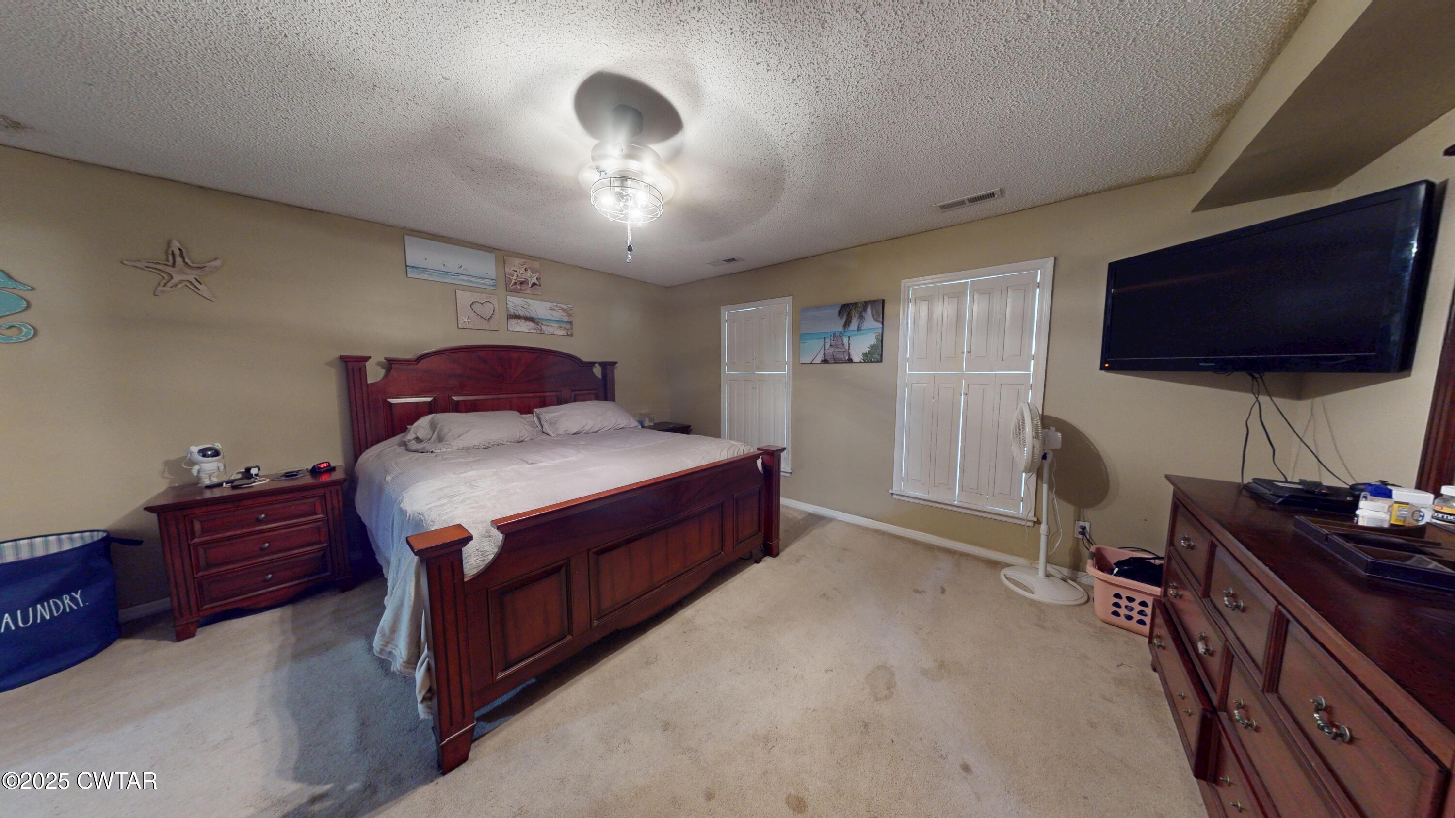 625 Hanna Drive Ripley, TN 38063 - Photo 8 of 26 a spacious bedroom with a bed and a flat screen tv