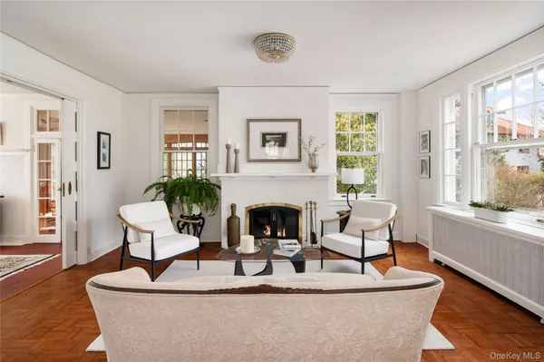 a living room with furniture a fireplace and a large window