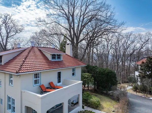 a view of a house with a yard and sitting area