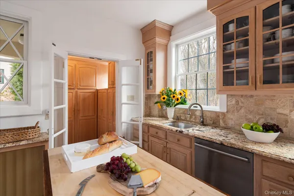 a kitchen with stainless steel appliances kitchen island granite countertop a sink table and chairs