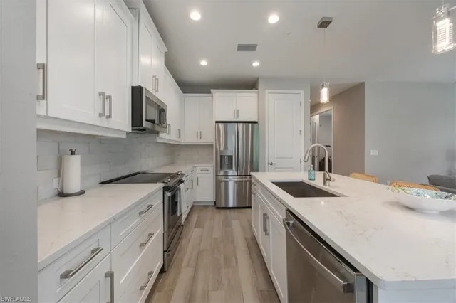 a kitchen with a sink stove and refrigerator