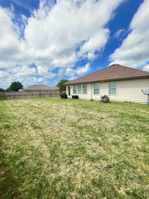 301 Long Prairie Drive Forney, TX 75126 - Photo 15 of 16 a view of a big yard with a building in the background