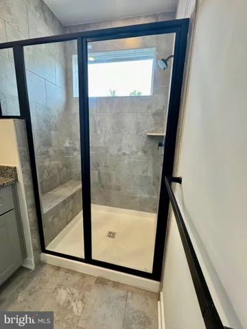 a bathroom with a glass shower door