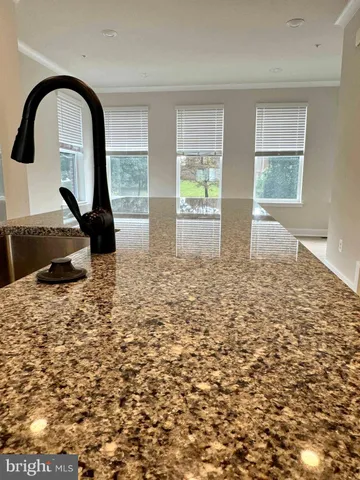 a large room with a wooden floor and a window