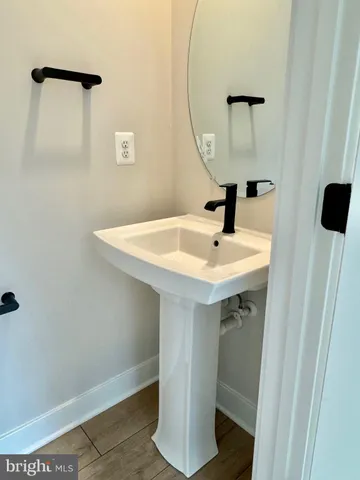 a bathroom with a sink a mirror and shower