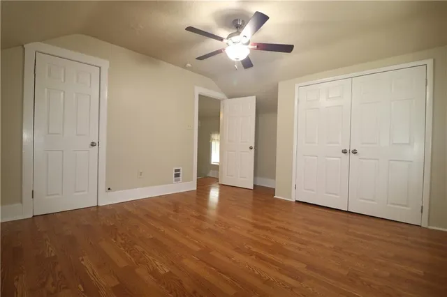an empty room with fan and a ceiling fan