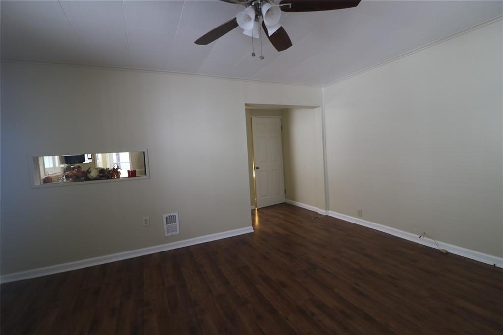 449 Spring Street Richeyville, PA 15358 - Photo 5 of 17 a view of an empty room with wooden floor and a ceiling fan