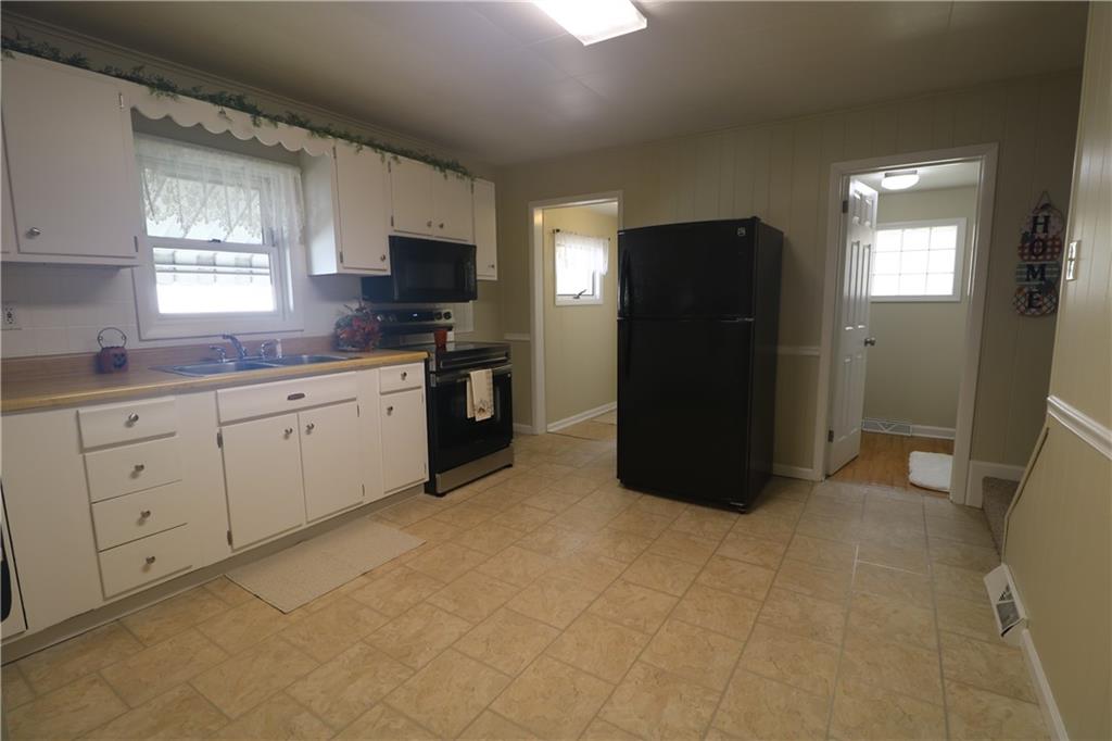 449 Spring Street Richeyville, PA 15358 - Photo 6 of 17 a kitchen with a refrigerator and a stove top oven