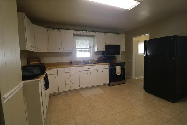 a kitchen with a sink and a refrigerator