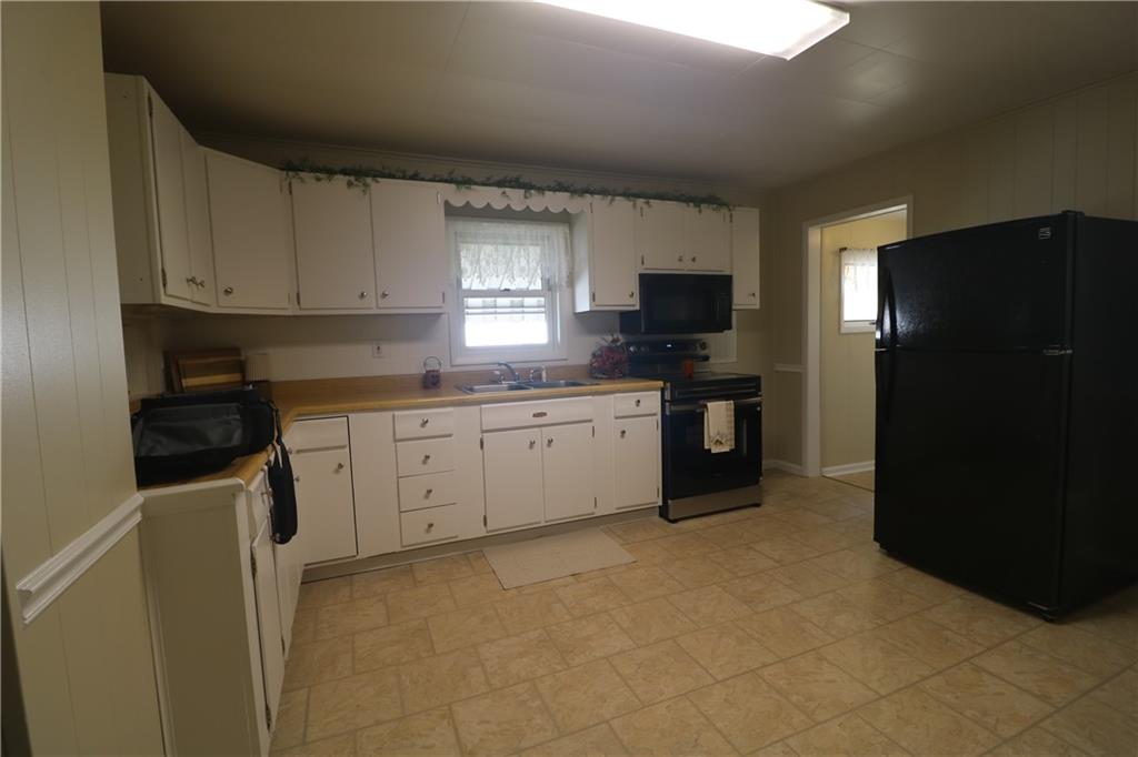 449 Spring Street Richeyville, PA 15358 - Photo 7 of 17 a kitchen with a sink and a refrigerator