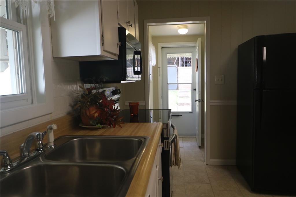 449 Spring Street Richeyville, PA 15358 - Photo 9 of 17 a kitchen with a sink stove and microwave