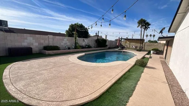 a view of a swimming pool with a patio