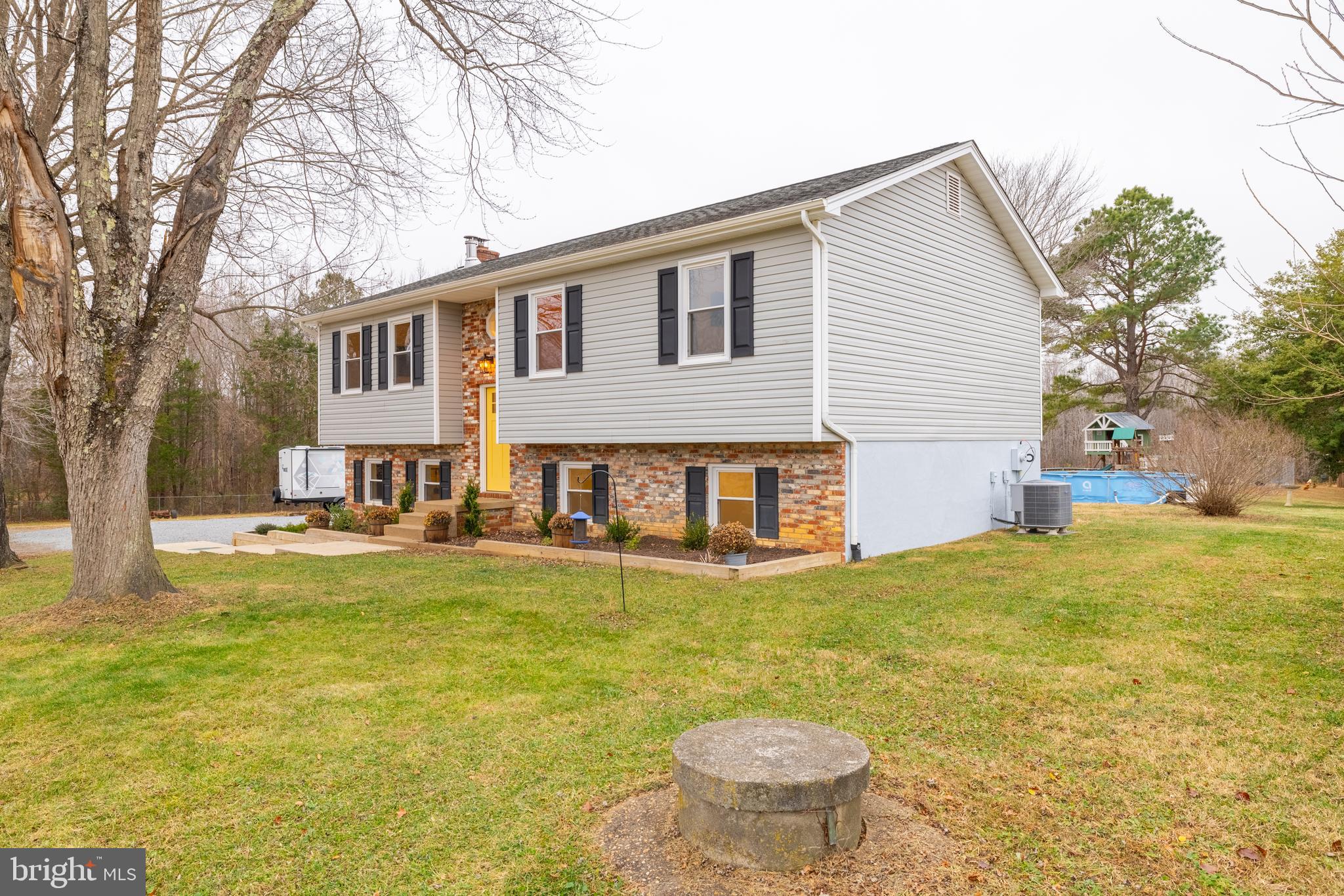 1251 Hartwood Road Fredericksburg, VA 22406 - Photo 28 of 28 a view of a house with pool and a yard