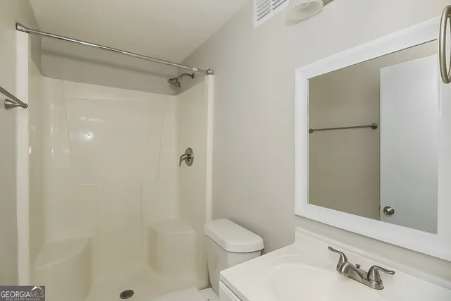 a bathroom with a shower and a toilet